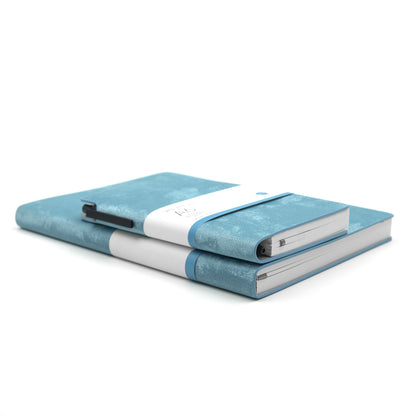 A set of two  blue velvet notebooks, one A5 size and one A6 size, with a blue ballpoint pen and labeled 'Velvet Series A5' and 'Velvet Series A6' respectively.