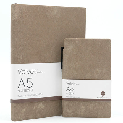 Two brown velvet notebooks, one A5 size and one A6 size, with a label indicating the brand and product size, placed side by side.
