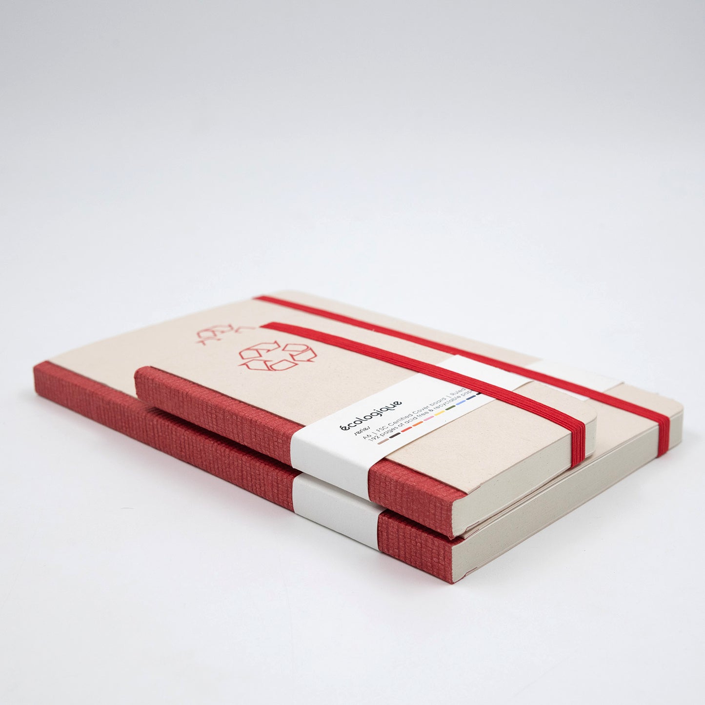 Beige and red notebook with a strap closure on a white background