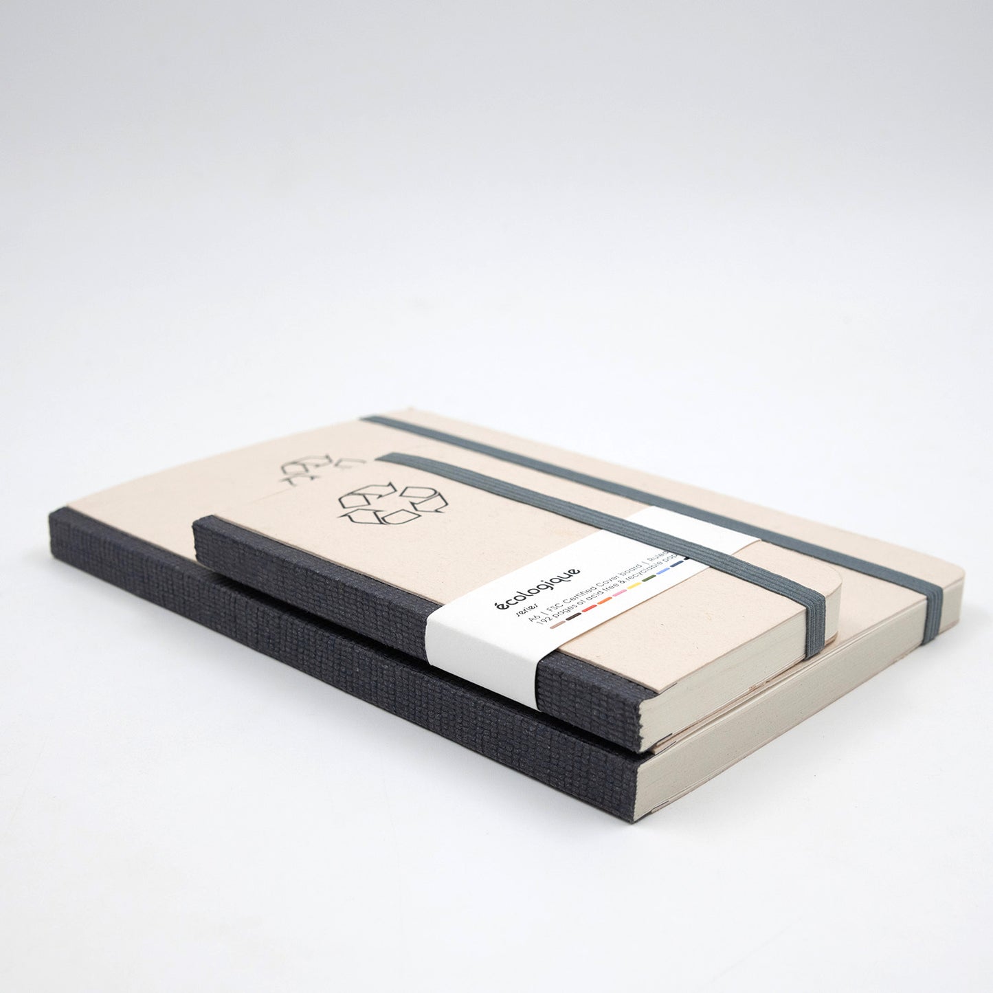 Two notebooks with black elastic bands on a white background