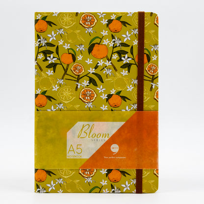 A5 size hard bound notebook with a lime green cover featuring a floral design and the brand 'Comma' visible.
