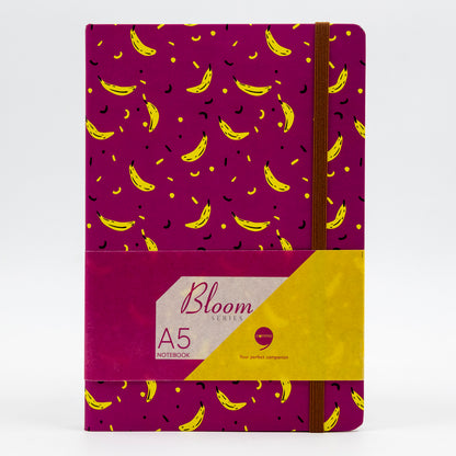 A5 size hard bound notebook with a purple cover featuring a nature-inspired design with yellow banana patterns and a floral-themed affirmation on the back cover.