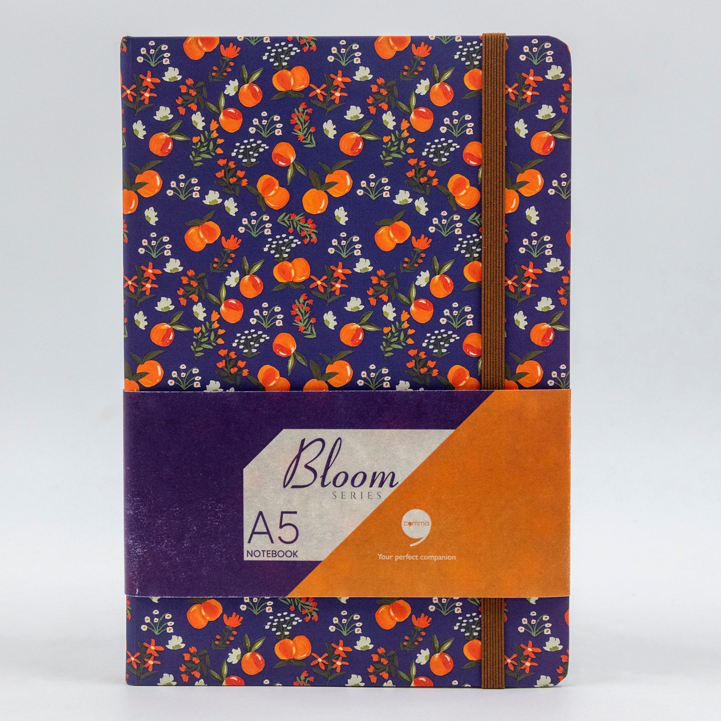 A5 size hard bound notebook with a floral design and a brown elastic band for securing the pages.