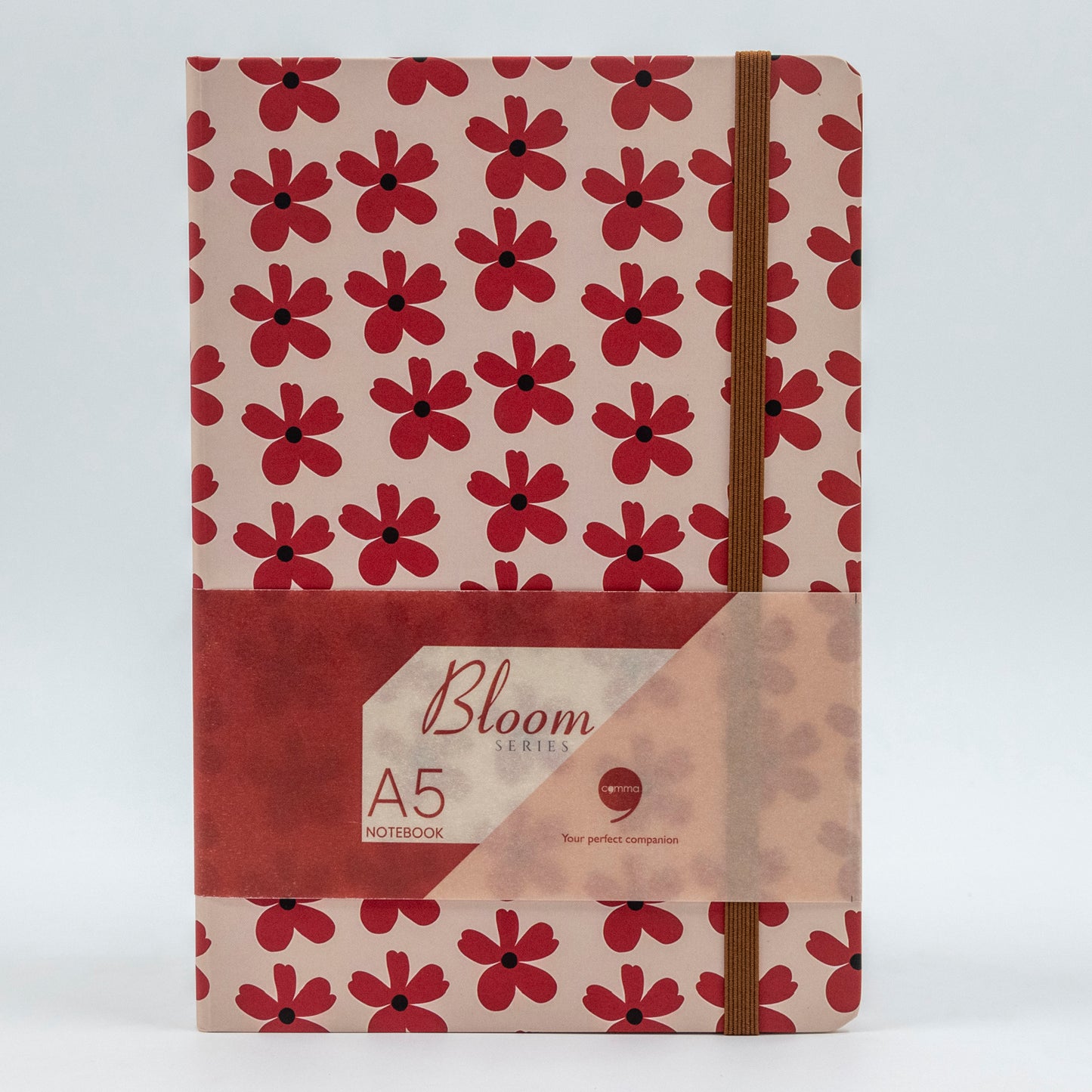 A5 size hard bound notebook with a red cover featuring a floral design and a brown spine, labeled 'Bloom Series'.