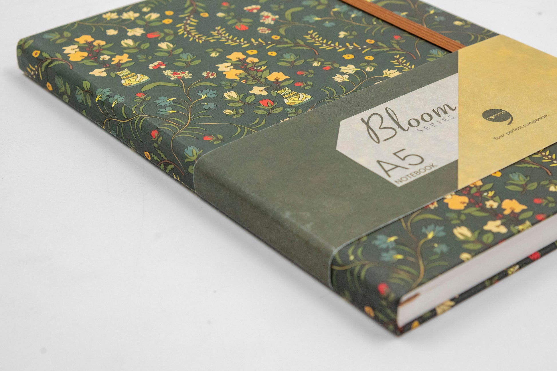 A5 size hard bound notebook with a green floral-themed design and a brown hard cover.