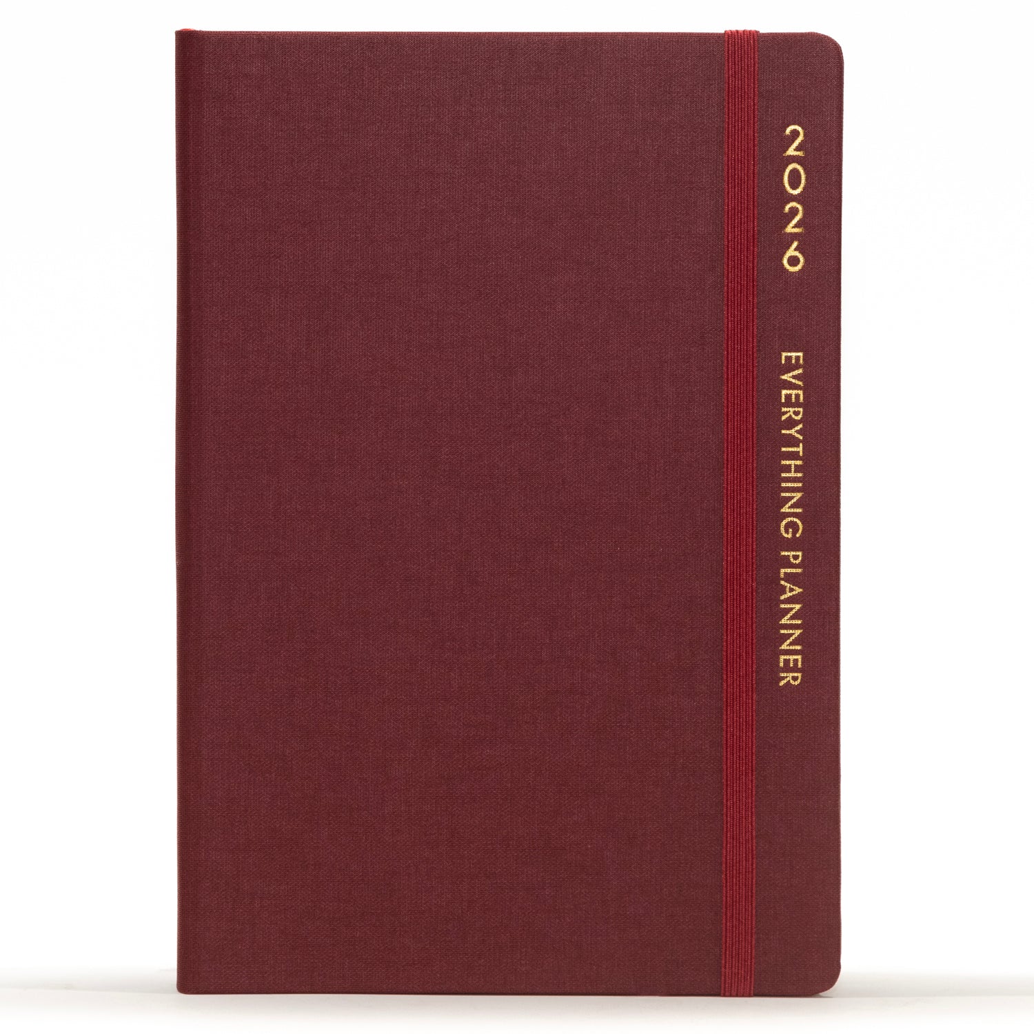 Maroon planner with a red strap and 'Comma' branding on a white background