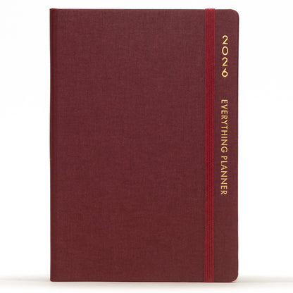Maroon planner with a red strap and 'Comma' branding on a white background