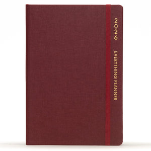Maroon planner with a red strap and 'Comma' branding on a white background