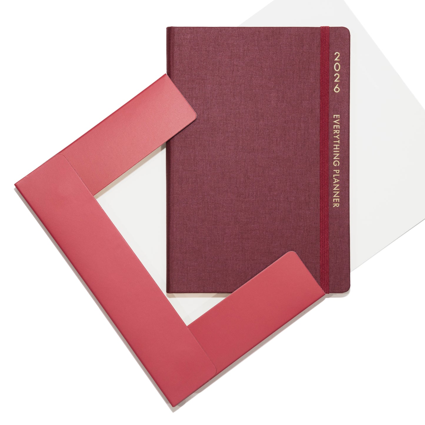 Maroon planner with pink cover on a white background