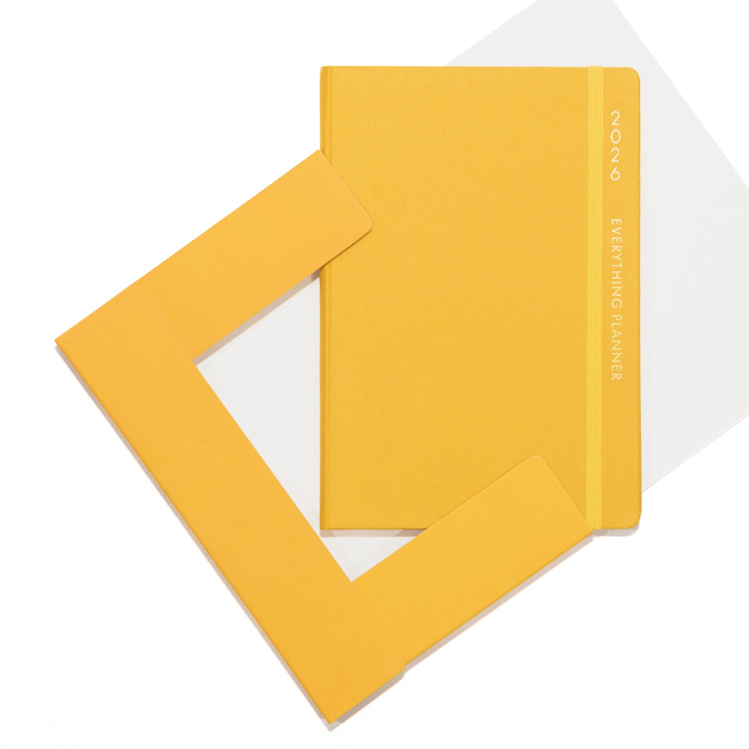 Yellow planner with a clear plastic cover on a white background