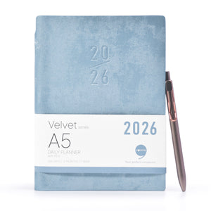 Blue A5 daily planner with a pen on a white background