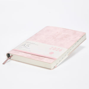 Pink planner with '2026' on a white background